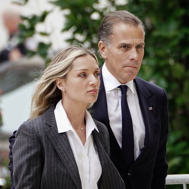 Hunter Biden wearing a dark suit, walks outside with his wife, Melissa Cohen Biden.